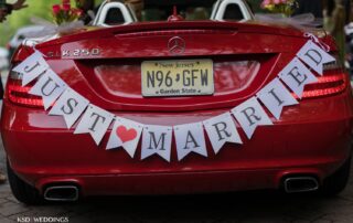 Close up of the Just Married sign tied onto the trunk of a red car at Brooklake Events in NJ